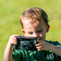 Little boy taking pictures with a digital camera